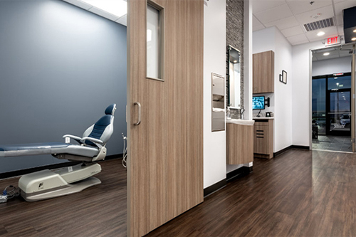 Hallway and dental treatment room in Pecan Grove dental office