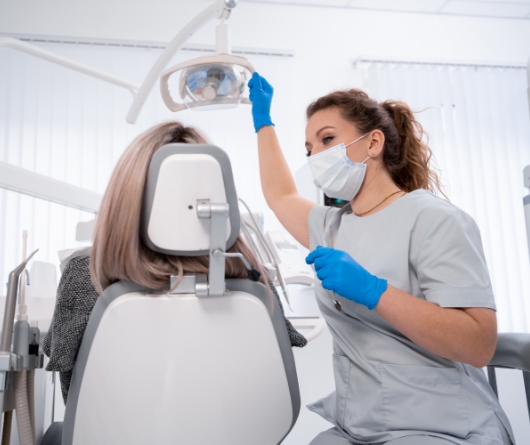 Dentist preparing to examine a patient's teeth