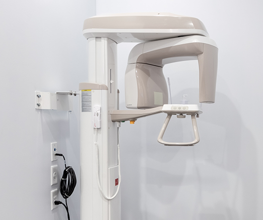 CT cone beam scanner standing against a white wall