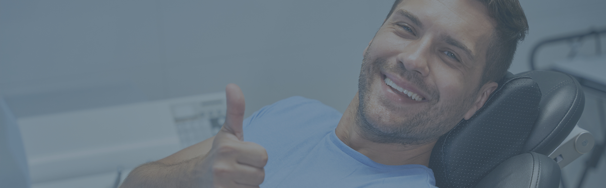 Young man giving a thumbs up at his dental appointment