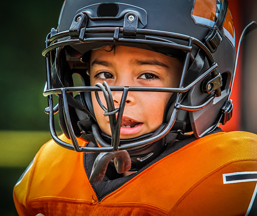 Young football player with a mouthguard