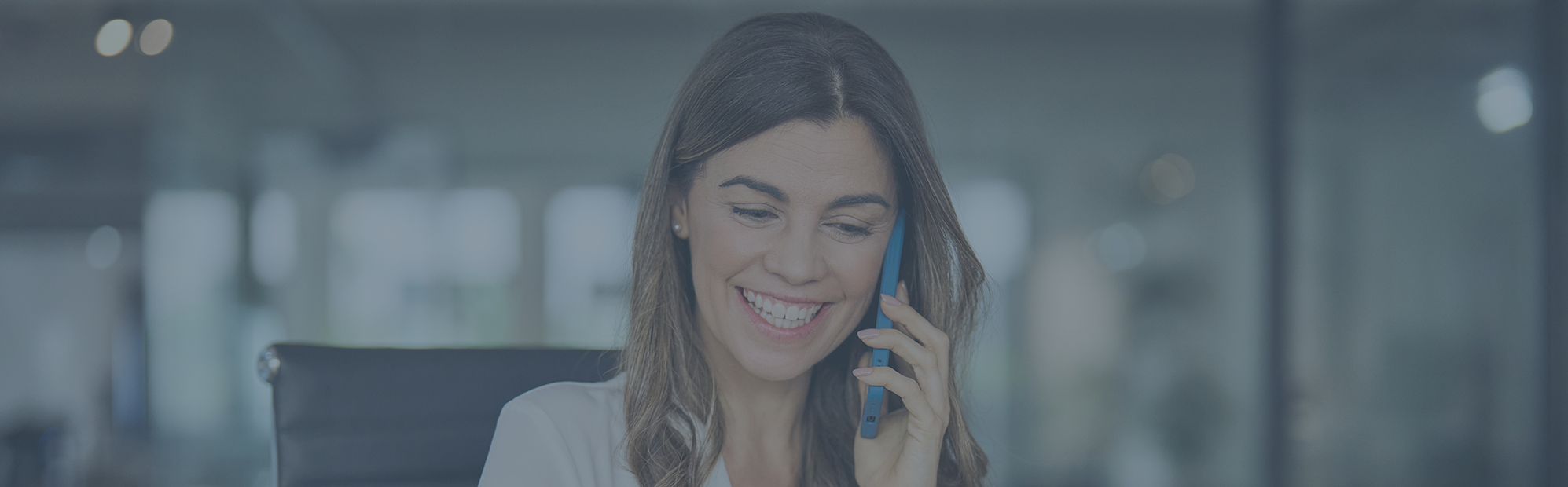 Woman talking on the phone with a dental office in Pecan Grove