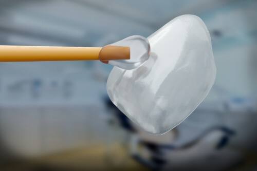 Close up of bonding agent being placed on a veneer