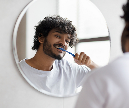 Young man brushing his teeth