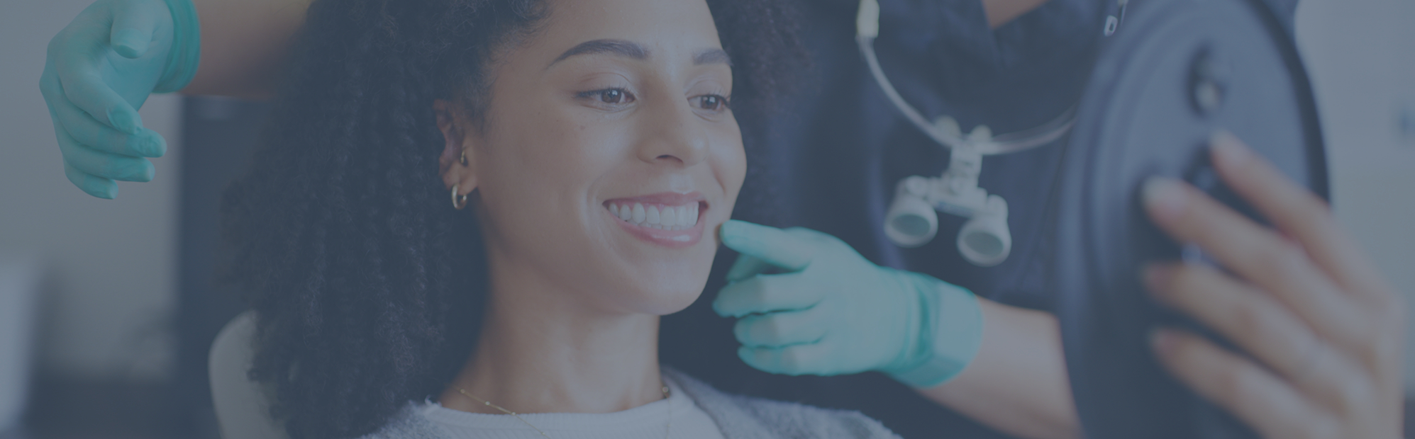 Dentist showing a patient her new smile in a mirror