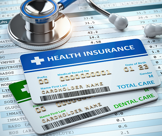 Health and dental insurance cards on paperwork