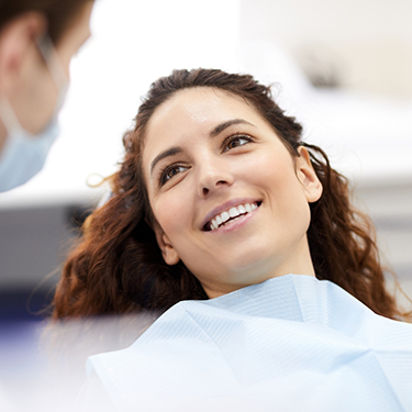 Brunette woman listening to her dentist
