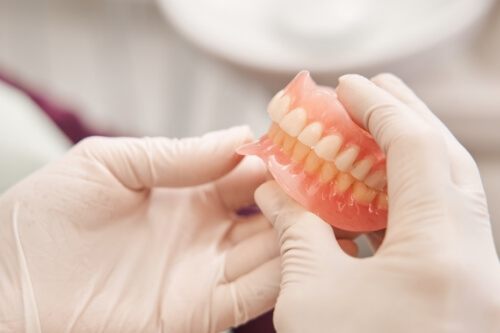 Dentist holding a set of full dentures