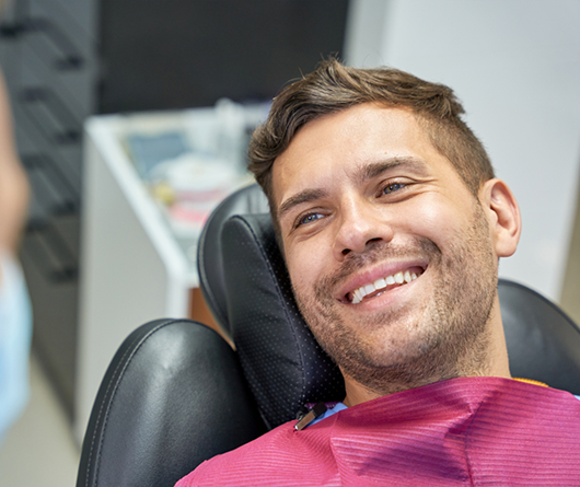 Young man smiling at his dentist