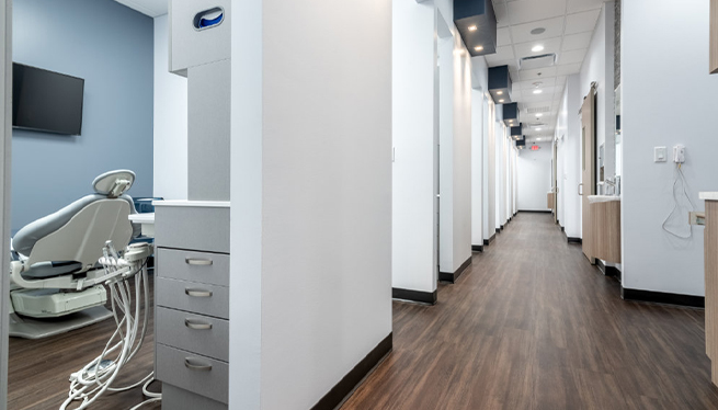 Long hallway branching off into several dental treatment rooms