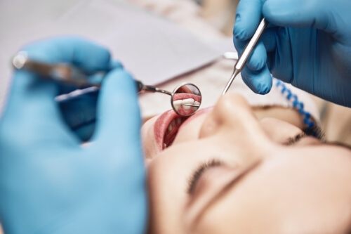 Dentist examining a patients mouth