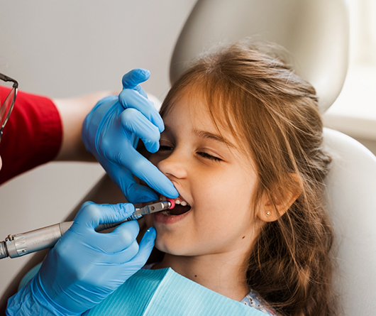 Young girl getting a dental cleaning