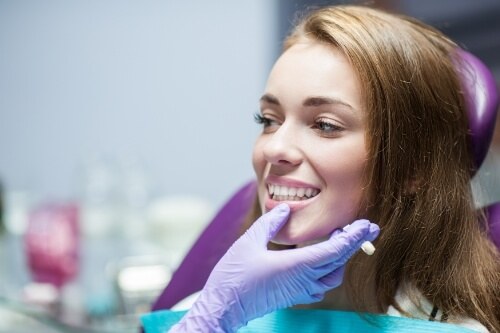 Woman smiling after treatment with restorative dentistry in Pecan Grove