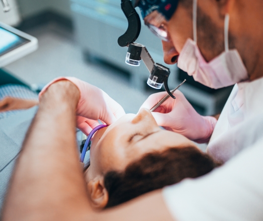 Dentist performing root canal treatment on a patient