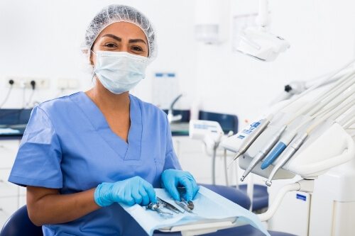 Smiling dentist getting ready to provide dental services in Pecan Grove