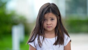 Little girl with scared look on her face.